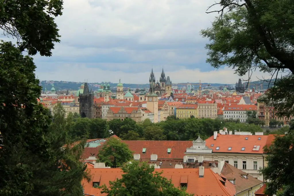 Panoramic view of Prague skyline with red rooftops and Gothic spires for teachers considering teaching English in Prague