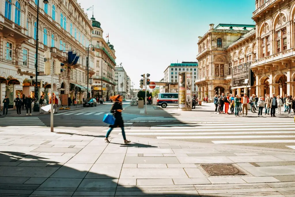 Pedestrians crossing a busy street in central Vienna — a city with a strong market for teaching English in Vienna