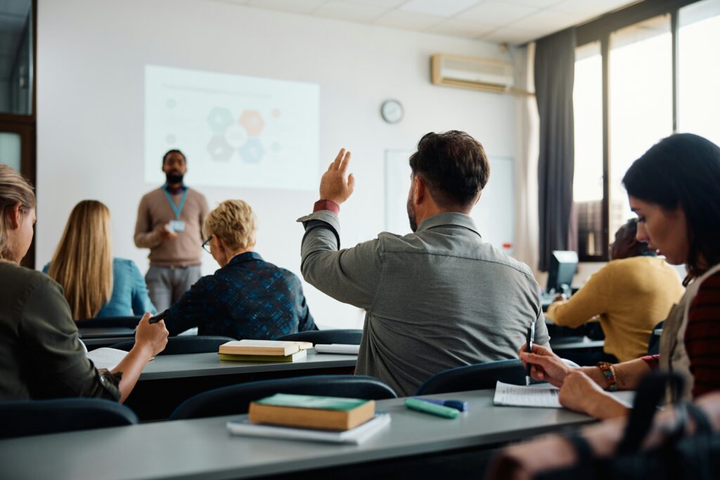 Adult students in an in person TEFL course abroad with instructor at the front of the classroom