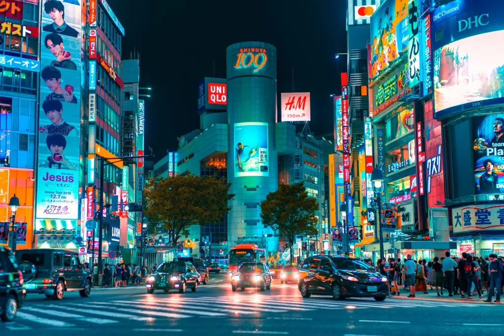 Shibuya district in Tokyo Japan at night with neon lights and traffic — a city where many JET Programme Japan teachers are placed