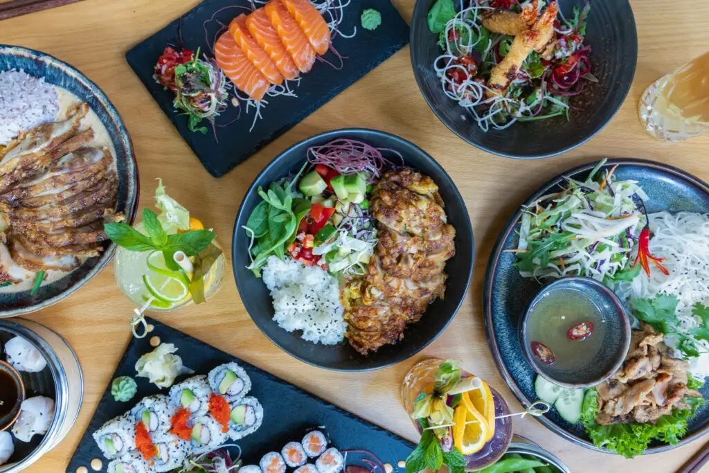 Spread of Japanese food dishes including sashimi sushi and rice bowls — the food culture JET Programme Japan teachers enjoy daily