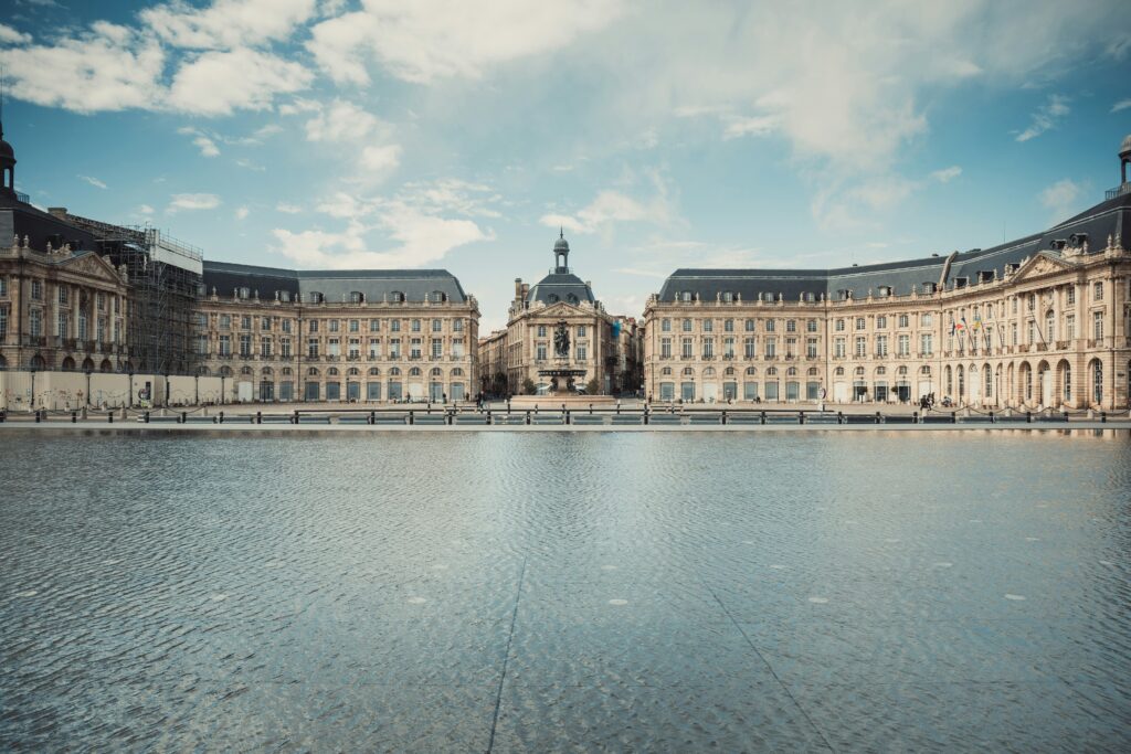 The Place de la Bourse and Miroir d'eau reflecting pool in Bordeaux, France — one of the beautiful regional cities where TAPIF teach English France assistants are placed