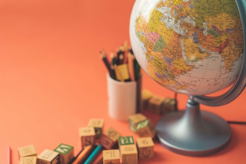 Classroom globe with pencils and alphabet blocks — planning to keep teaching license active abroad