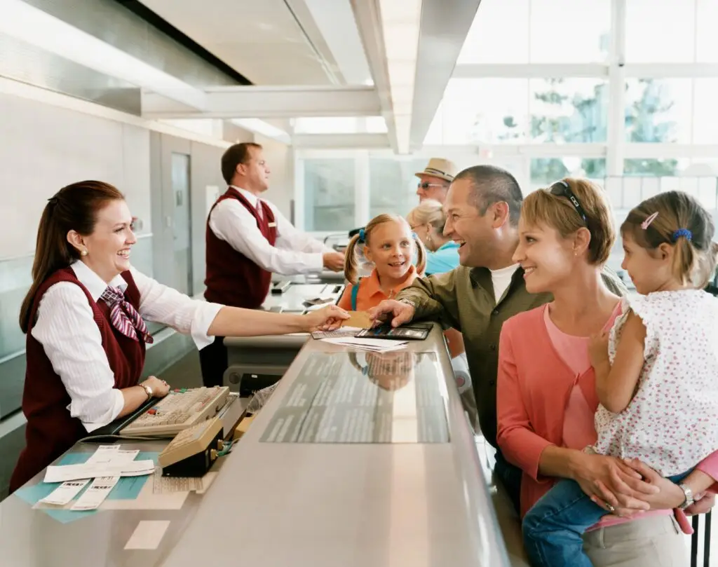 Family checking in at an airport counter — teaching abroad with a partner or family
