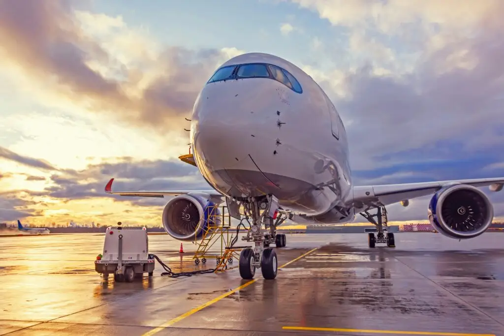 Airplane on tarmac at sunset — Fulbright English Teaching Assistant covers round-trip flights