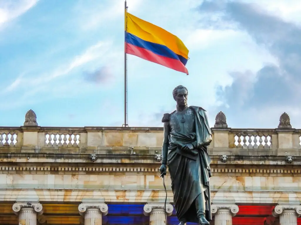 Simón Bolívar statue and Colombian flag in Bogotá — teach English in Colombia