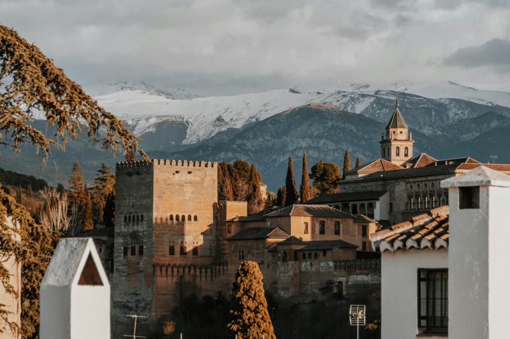 The Alhambra fortress in Granada with snow-capped Sierra Nevada mountains behind it — the kind of weekend view that awaits Meddeas Spain program language assistants in southern Spain