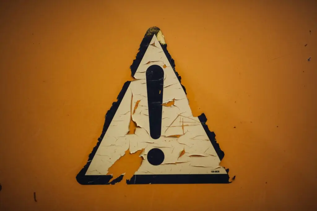 Weathered caution warning sign — red flags to watch for before signing a teaching abroad contract