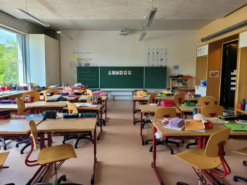 European classroom desks and chalkboard — where teachers work while keeping their teaching license active abroad