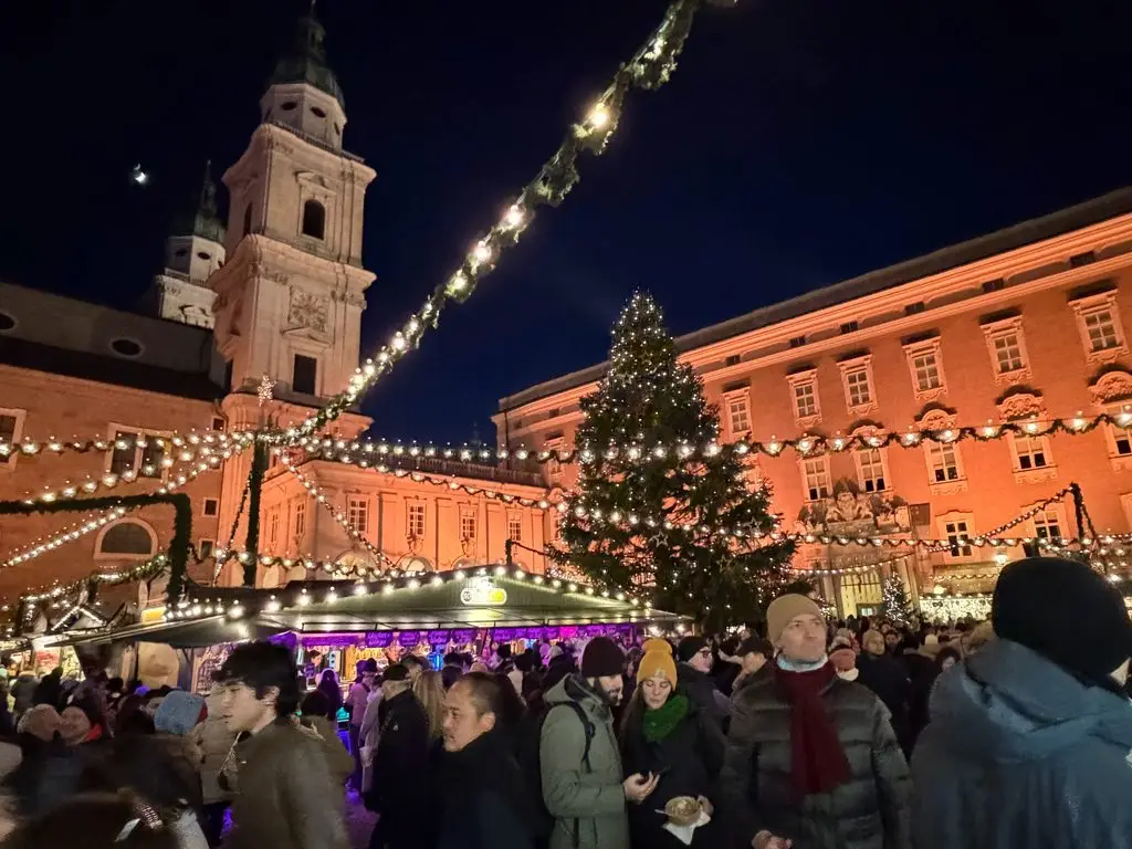Salzburg Domplatz Christmas market at night with cathedral and lit tree