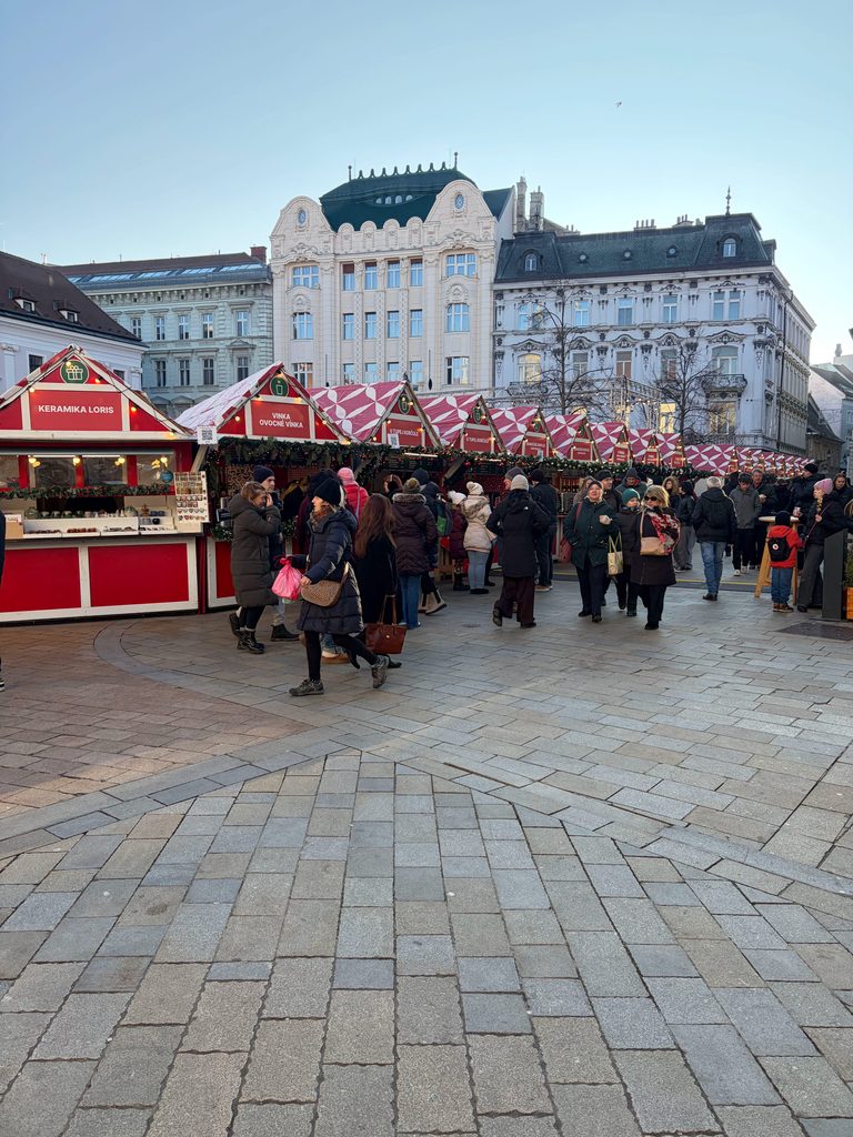 Bratislava Old Town Christmas market with red-striped stalls and Art Nouveau building