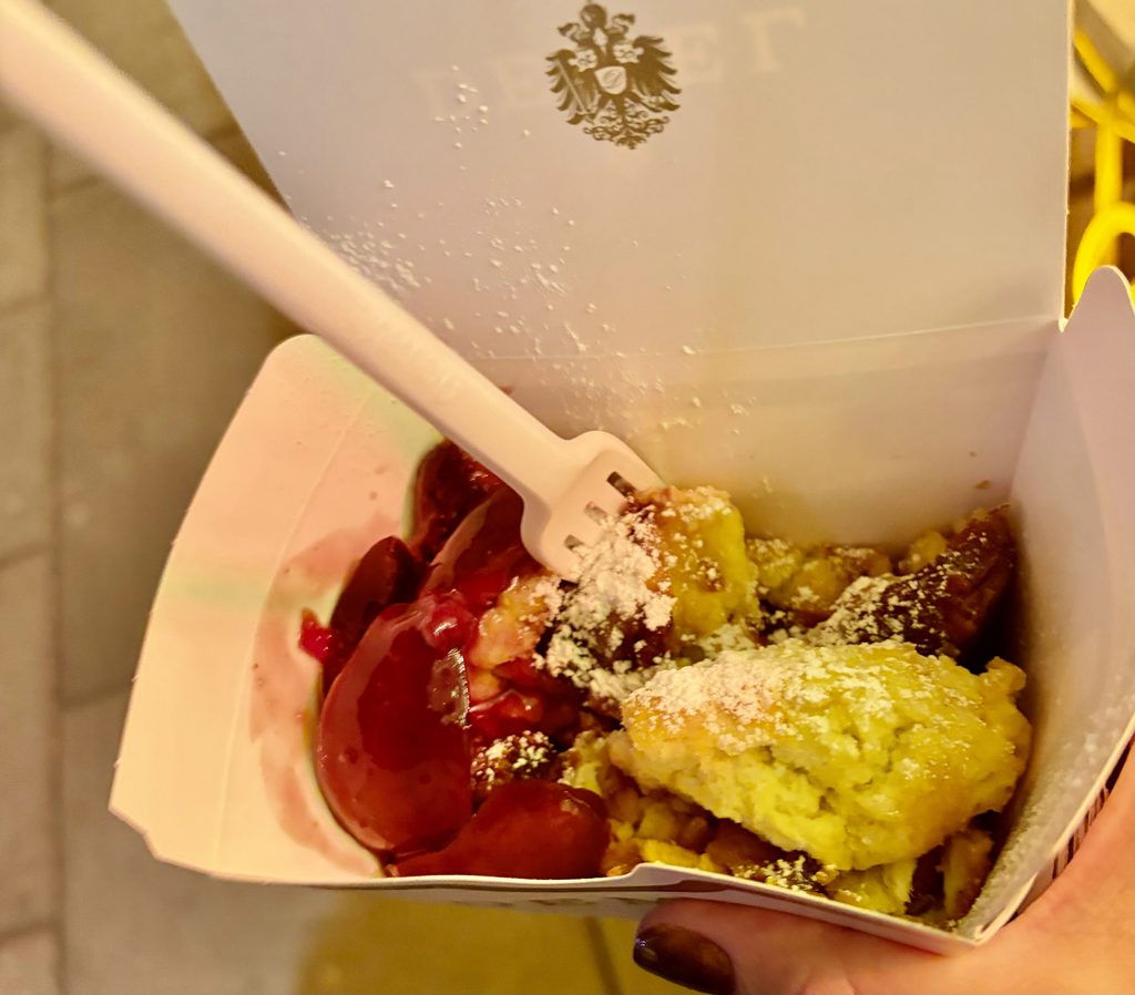 Vienna travel guide: Demel's Kaiserschmarrn, torn pancake with plum compote and powdered sugar, in a takeaway box.