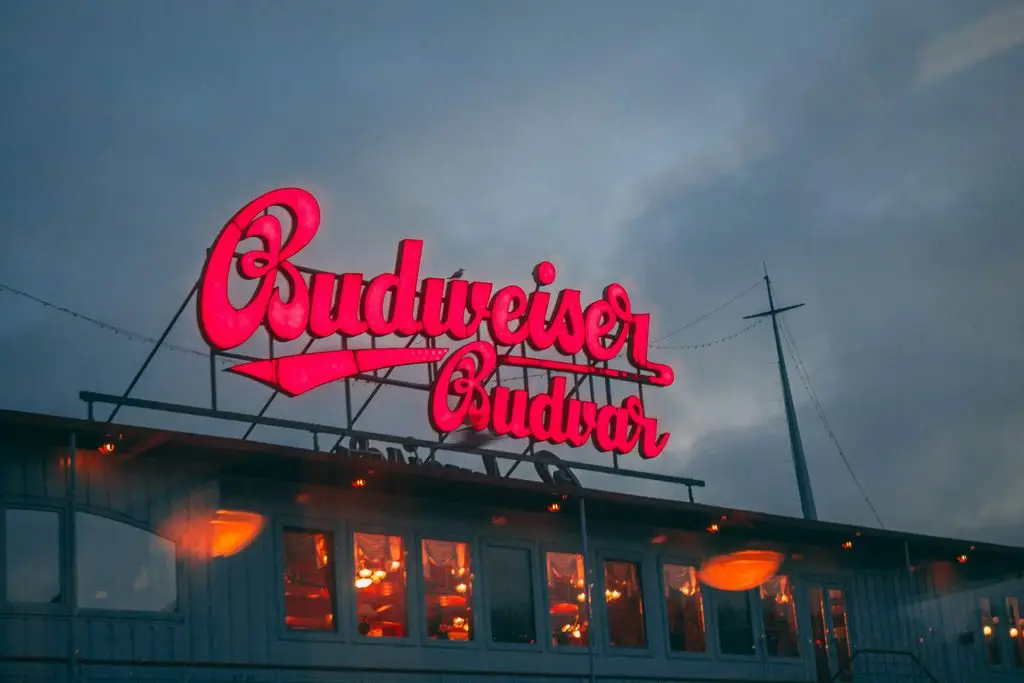 Neon "Budweiser Budvar" sign at dusk, the original Czech brewery in České Budějovice.