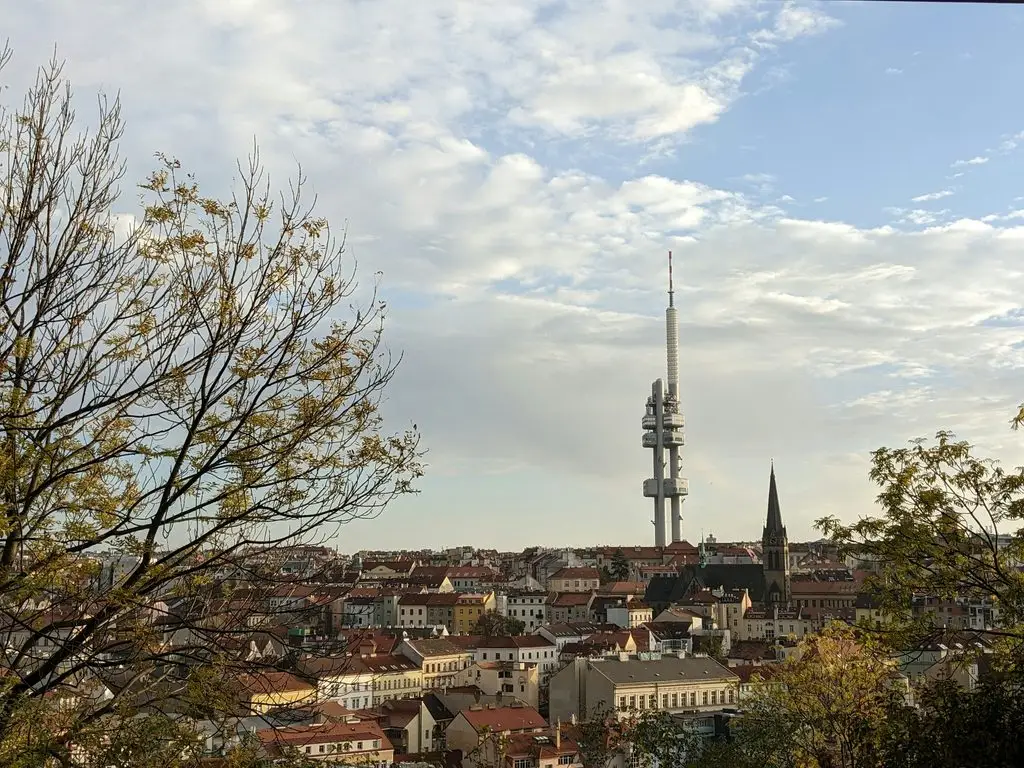 Žižkov Television Tower rising above Prague rooftops in autumn