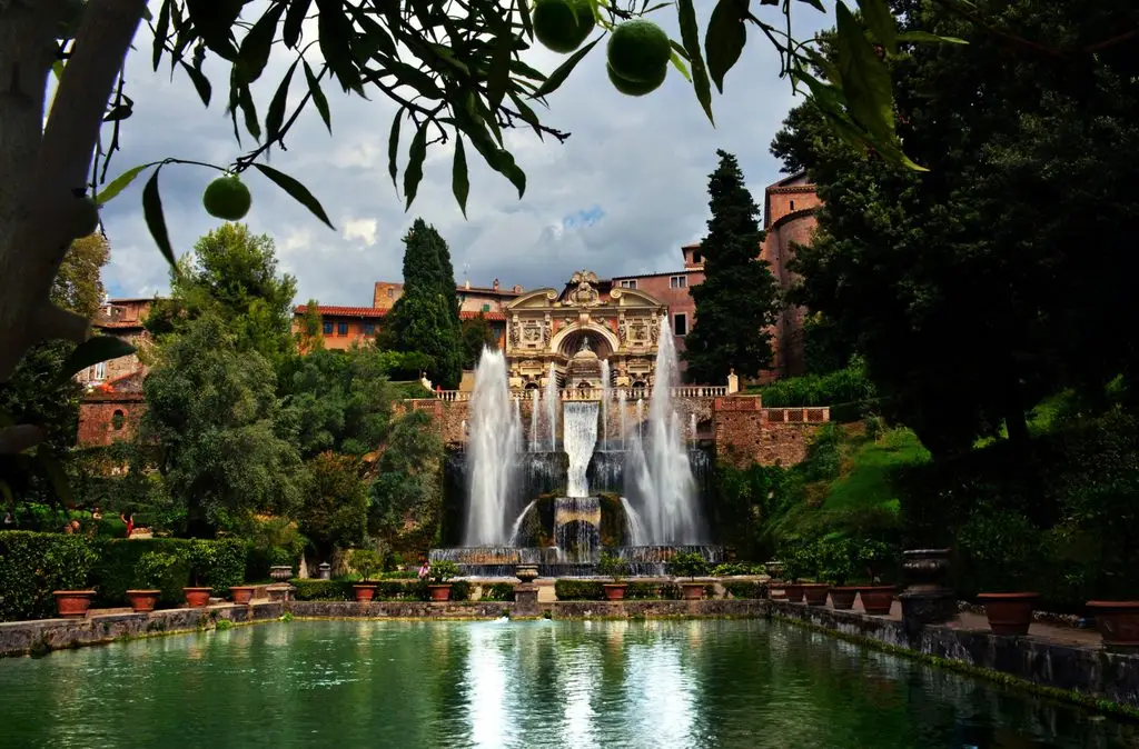 Day trip from Rome: the Fountain of Neptune at Villa d'Este in Tivoli, framed by citrus trees.
